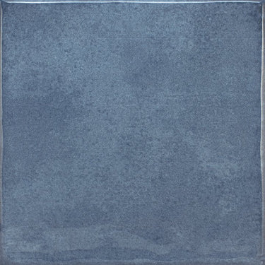 Roca Olaria blue steel 2x6 bullnose wall tile showing a close-up of the textured blue ceramic surface
