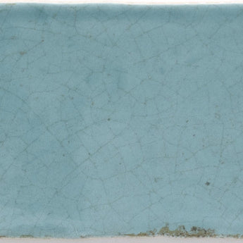 Blue steel crackled Maiolica wall tile by Roca, measuring 3x12 inches, with a textured, glazed surface and intricate crackle design.