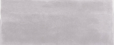 Roca Maiolica Matte Tender Gray wall tiles, 4x10 inches, shown in a close-up image highlighting their matte finish and subtle gray color.